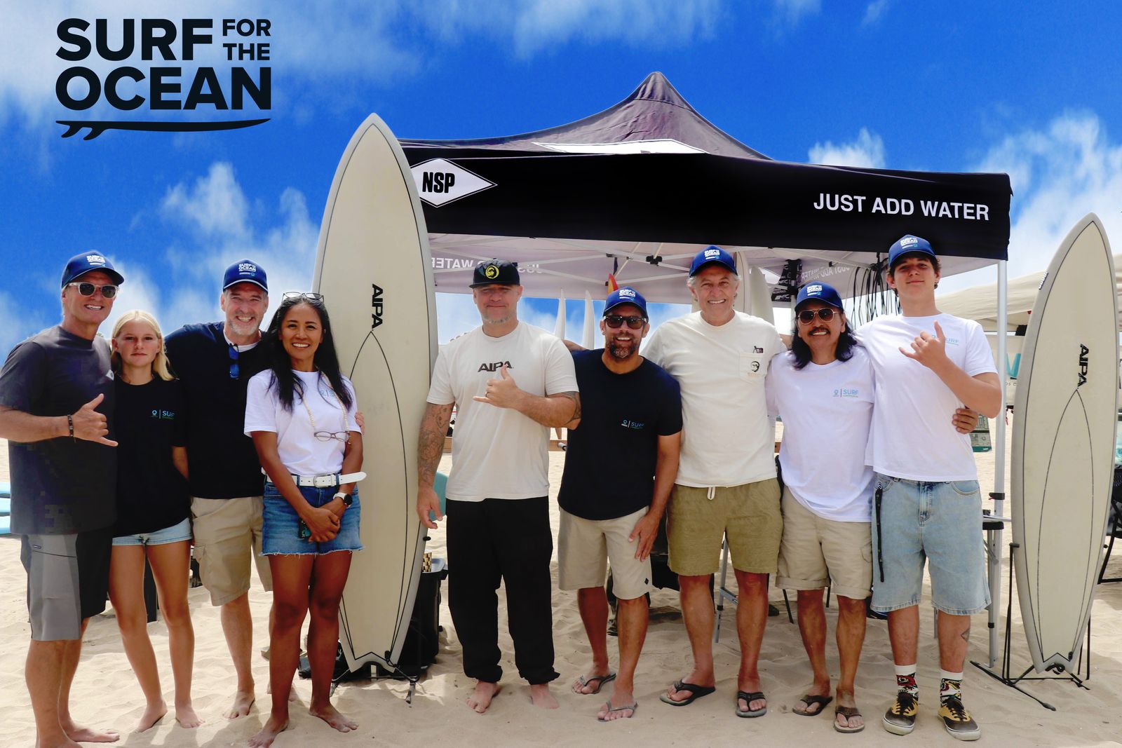 Surf for the Ocean at the Huntington Beach pier: the crew with sponsored boards under the event canopy